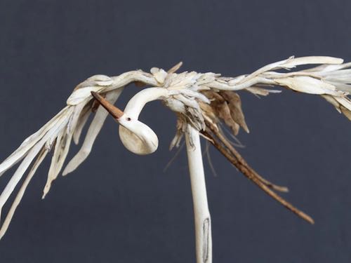 artist: Cindy English Gillis - driftwood sculpture, great egret flying above the trees